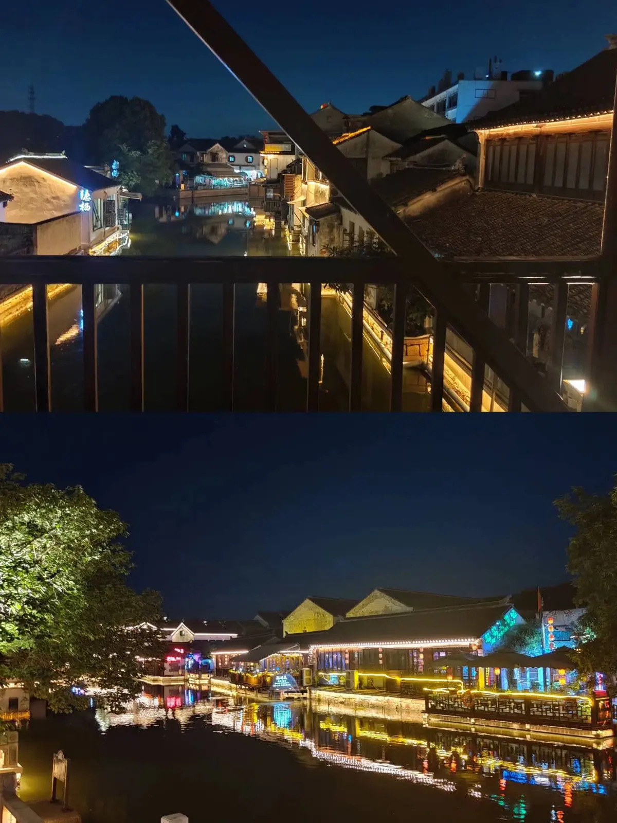 A night view of a riverside or lakeside area with lights and buildings.