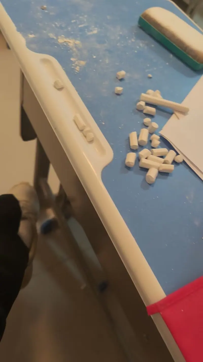 Small white pieces scattered in a drawer or container.